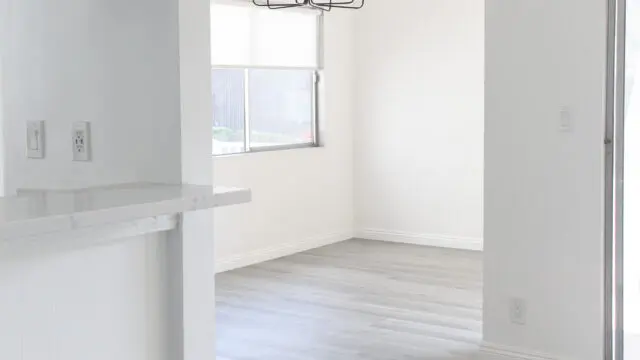 Minimalist empty room with chandelier lighting.