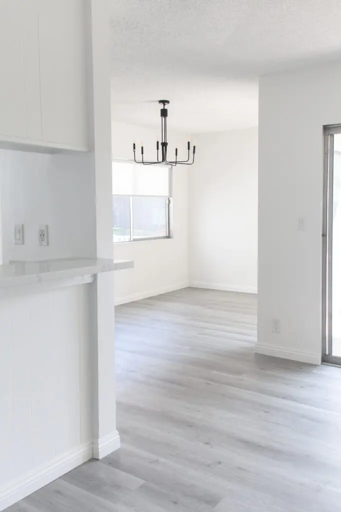 Minimalist empty room with chandelier lighting.