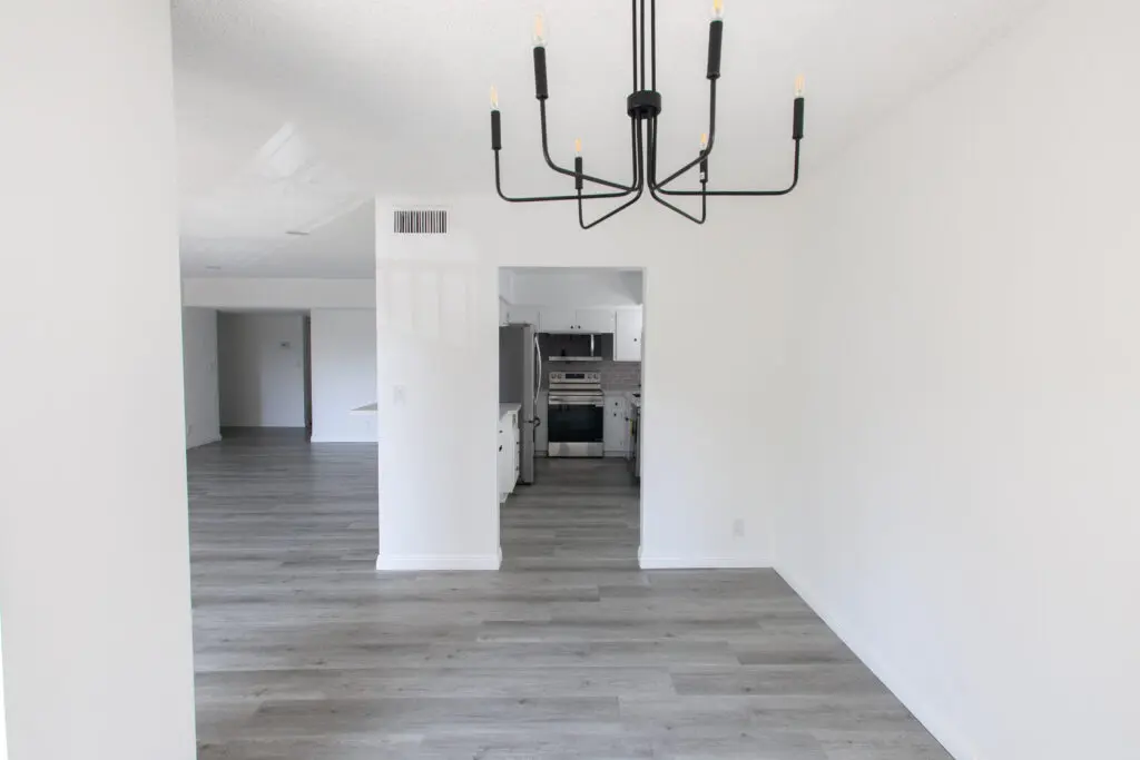 Minimalist empty room with modern chandelier.