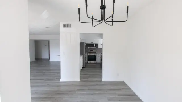 Minimalist empty room with modern chandelier.