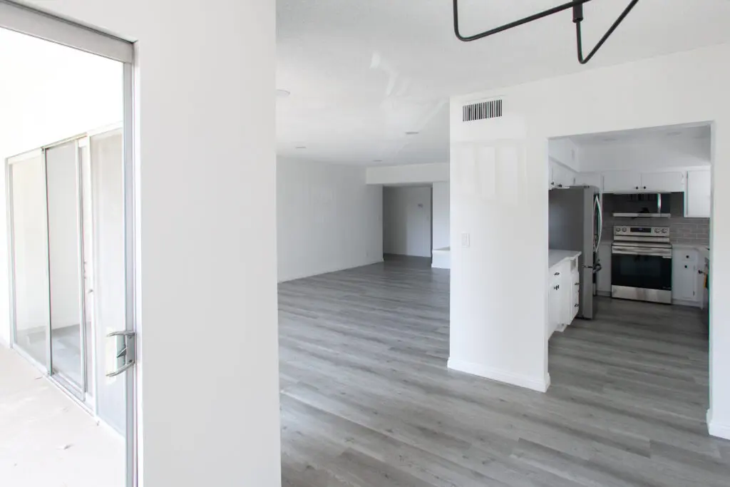 Empty modern apartment with gray flooring.