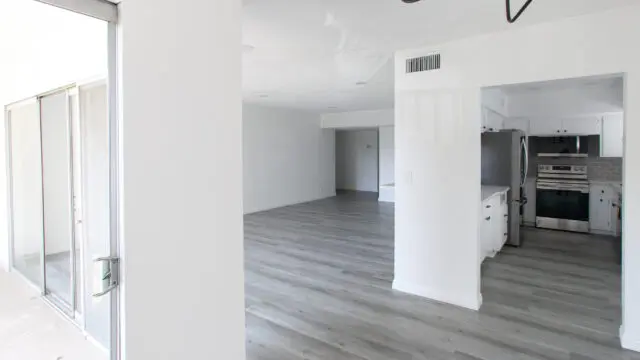 Empty modern apartment with gray flooring.